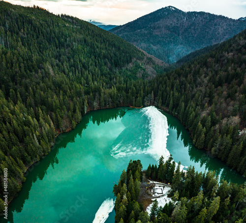 Synevyr lake in the Carpathians, top view of the lake, mountain lake covered with ice, ice line on Synevyr lake. photo