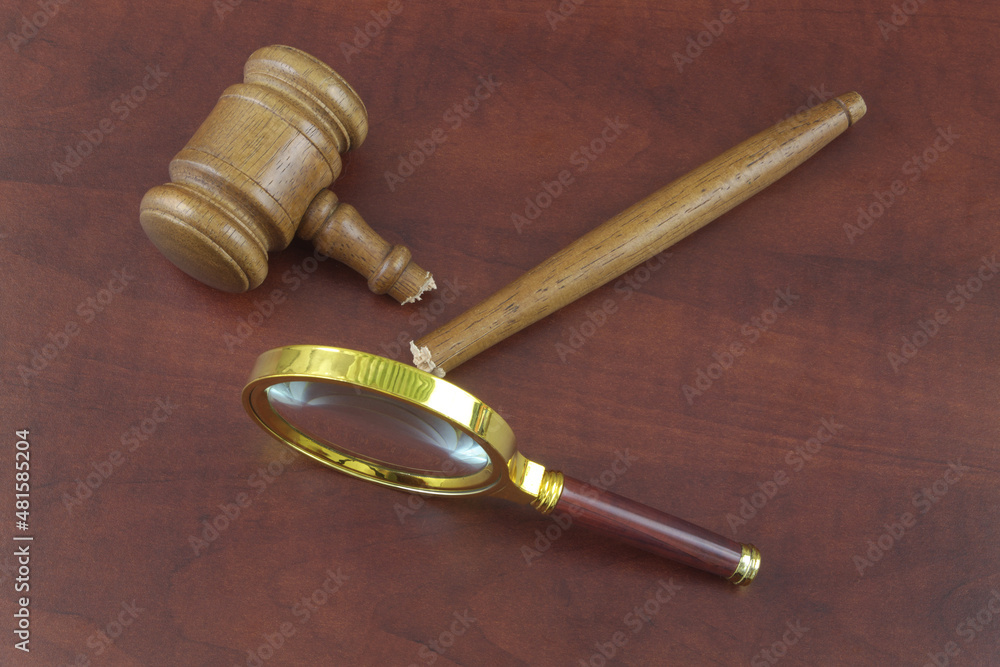 Broken legal system review concept. Damaged judge gavel and magnifying glass. Broken legal system review concept. Damaged judge gavel and magnifying glass.