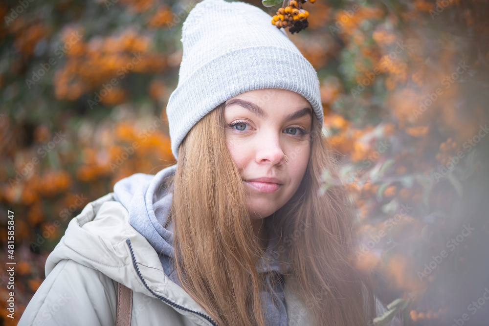 portrait of a woman against the background of frozen branches of yellow rowan, blonde against the background of snowy yellow berries, Beautiful young woman portrait of a woman against the background of frozen branches of yellow rowan, blonde against the background of snowy yellow berries, Beautiful young woman