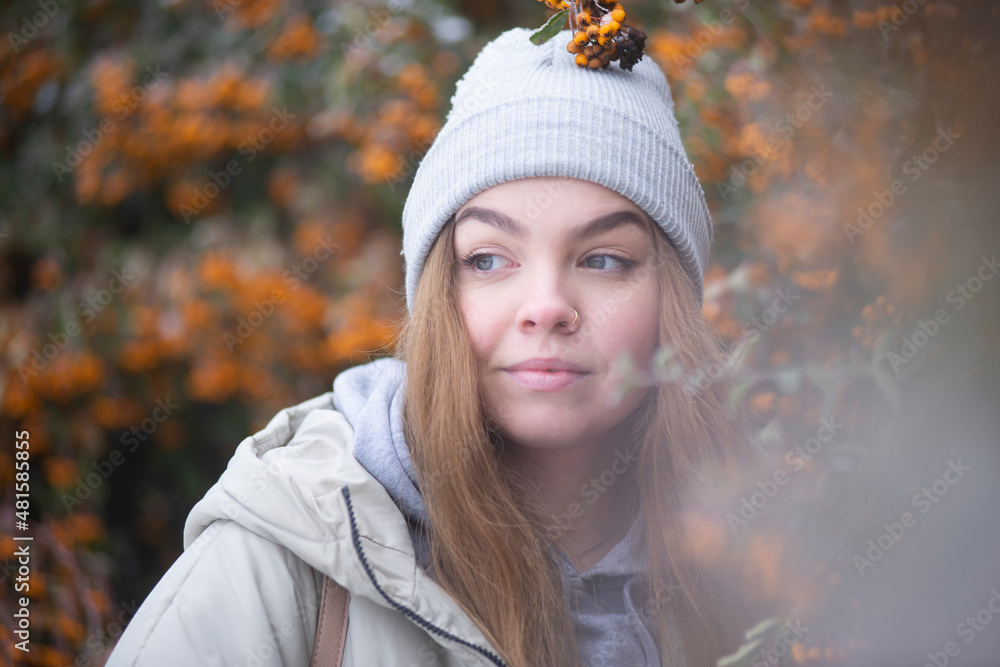 portrait of a woman against the background of frozen branches of yellow rowan, blonde against the background of snowy yellow berries, Beautiful young woman portrait of a woman against the background of frozen branches of yellow rowan, blonde against the background of snowy yellow berries, Beautiful young woman