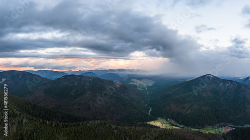 Cloudy skies over the mountains, rainy spring clouds over the forest and mountain tops.