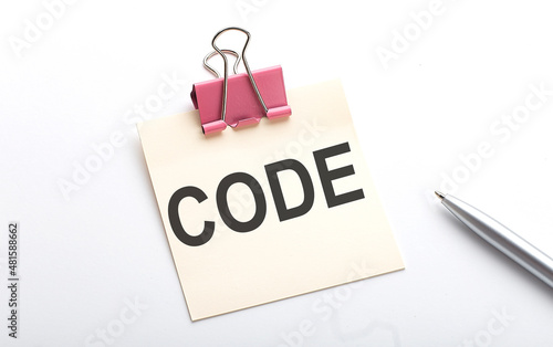 CODE text on the sticker with pen on white background