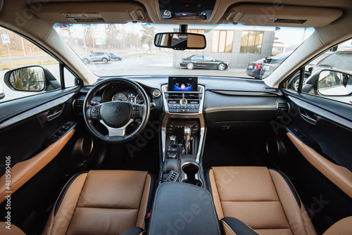 Modern luxury car Interior - steering wheel, shift lever and dashboard. Car interior luxury inside. Steering wheel, dashboard, speedometer, display.Yellow leather interior.