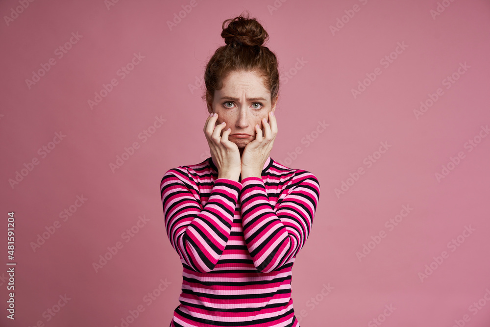 Studio shot of young woman with sad face Studio shot of young woman with sad face