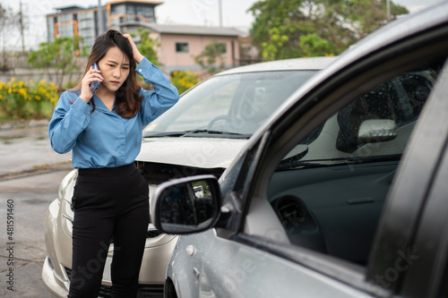 Woman drivers call insurance after a car accident before taking pictures and sending insurance. Online car accident insurance claim idea after submitting photos and evidence to an insurance company. © Prot