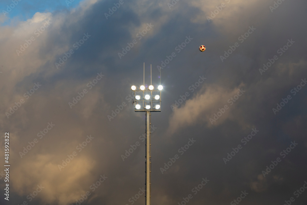 Lighting of a soccer field with storm clouds in the background Lighting of a soccer field with storm clouds in the background