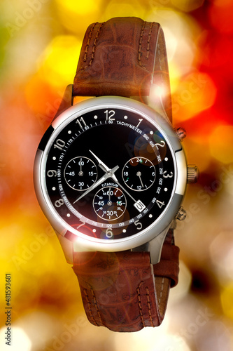 wristwatch for man on color lights background photo