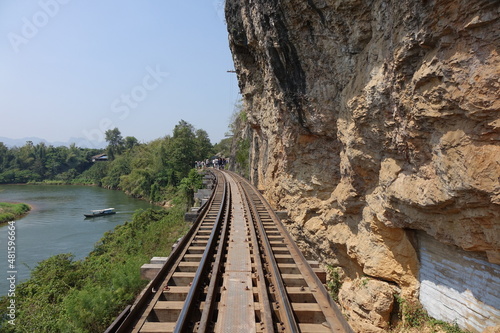 Tracks of Thai Burma Railway (Death Railway) winding along the steep shore of River Kwae Noi on Tham Krasae Bridge (horizontal image), Kanchanaburi, Thailand