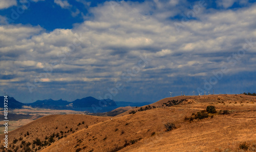 Mountain landscape. View of the mountain hills. Sunny, cloudy day. 