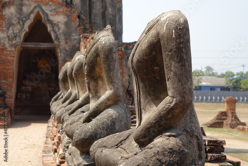 Line of headless statues at Wat Chai Watthanaram temple  Ayutthaya  Thailand  horizontal image 