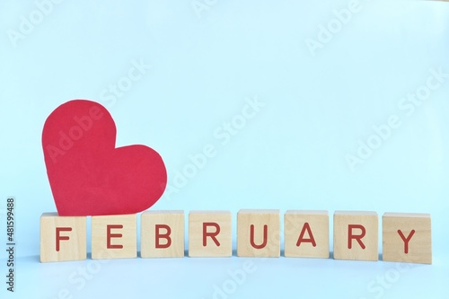 Love month of february in wooden blocks with red heart shape. Hello Valentine season celebration. photo