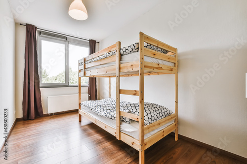 Lovely bedroom with wooden bunk bed and chandelier photo