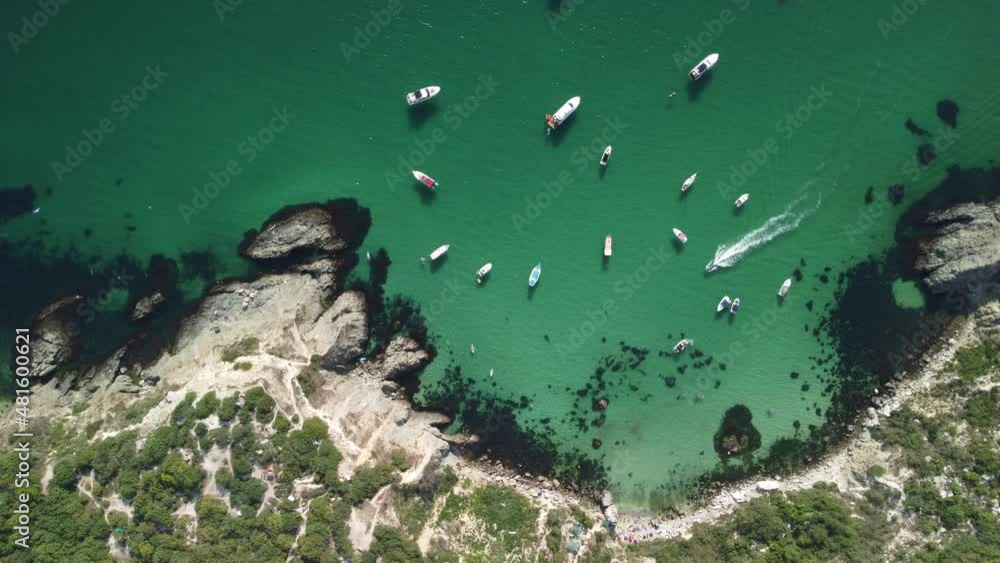 Aerial panoramic view of seascape with crystal clear azure sea and rocky shores. Yachts in a beautiful lagoon on backdrop of rocks. The concept of an ideal destination for summer travel and vacation. Aerial panoramic view of seascape with crystal clear azure sea and rocky shores. Yachts in a beautiful lagoon on backdrop of rocks. The concept of an ideal destination for summer travel and vacation.