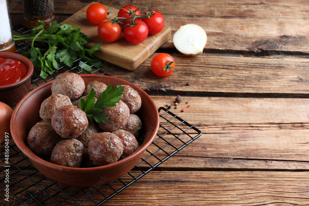 Tasty cooked meatballs with parsley on wooden table. Space for text Tasty cooked meatballs with parsley on wooden table. Space for text