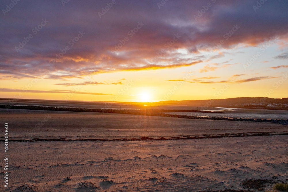 Sunset along Llanelli beach in Wales.