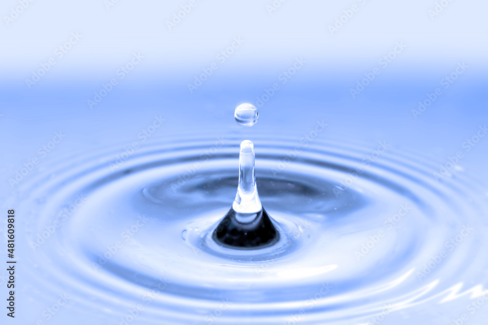 Water drop falling into water Water drop falling into water