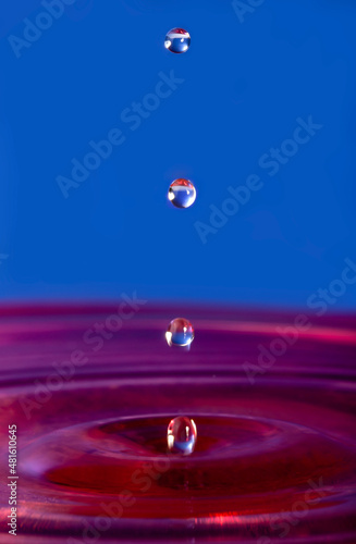 Water drop falling into water