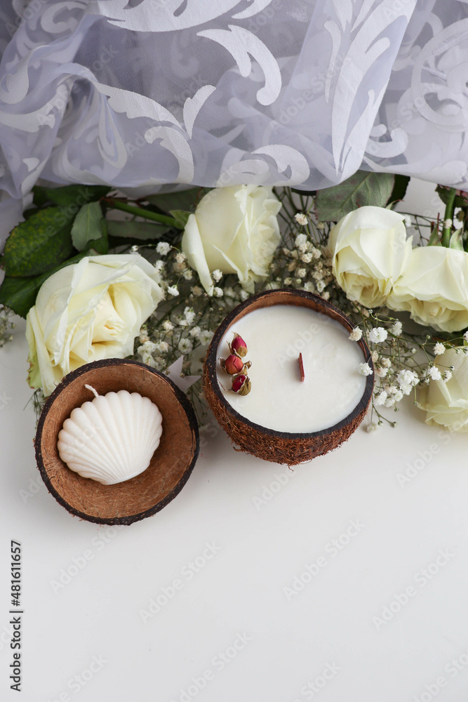 original decorative candle in a coconut. natural soy wax candle and a bouquet of white roses original decorative candle in a coconut. natural soy wax candle and a bouquet of white roses