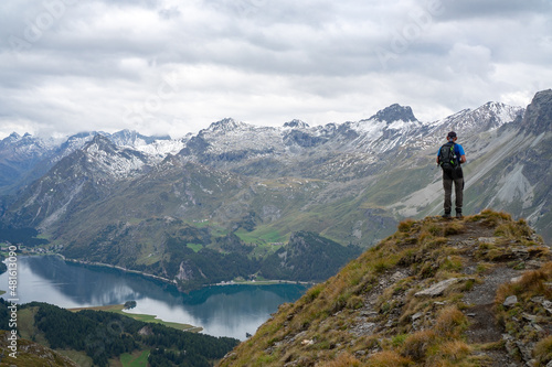 Hikers on the hiking trail with backpack mountain lake as background beautiful view

