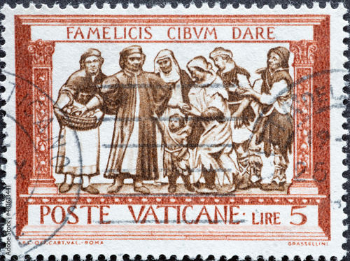 Vatican City - circa 1960: a postage stamp from Vatican City , showing a depiction of “Feeding the Hungry” (Della Robbia)