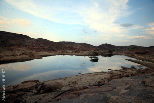 A small lake in the desert with sky reflected in the water © Mahmoud