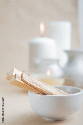 Palo Santo bars close-up and copy space. Ritual cleansing with sacred ibiocai, meditation, aromatherapy with incense and candles..