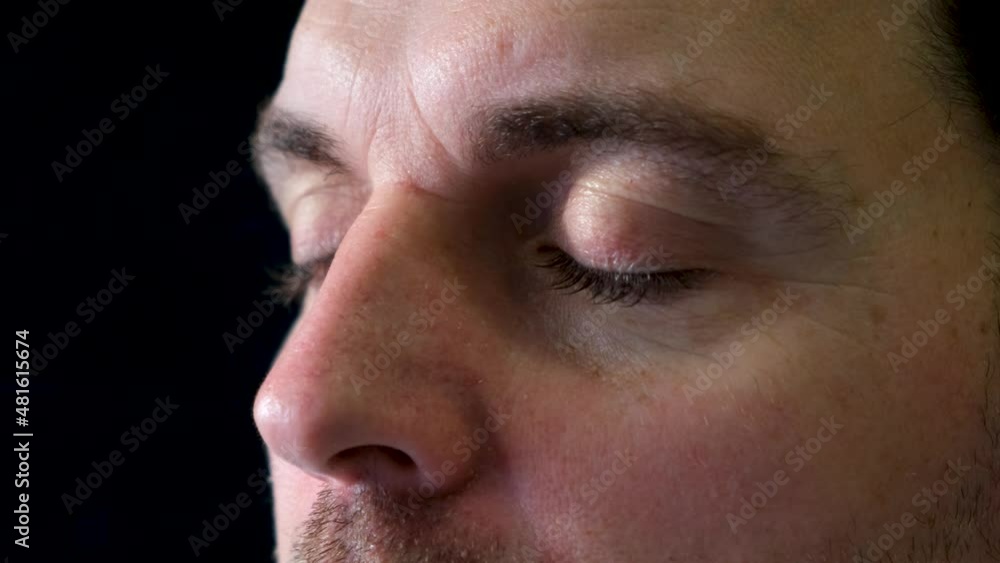bright blue eyes men look into the distance thoughtfully on a black background bright blue eyes men look into the distance thoughtfully on a black background