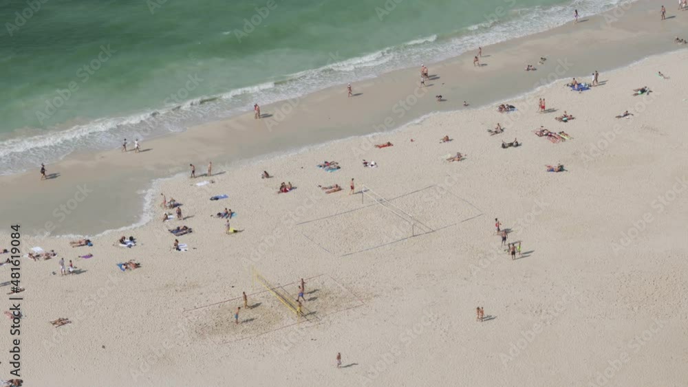 Aerial view on people walking on the beach playing volleyball Aerial view on people walking on the beach playing volleyball