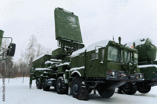 Heavy military equipment of Russian armed forces against the background of a winter forest photo