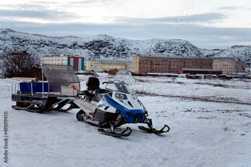 snowmobile with a trailer for transporting tourists in the village of Teriberka, Russia, Kola poluostrov. photo