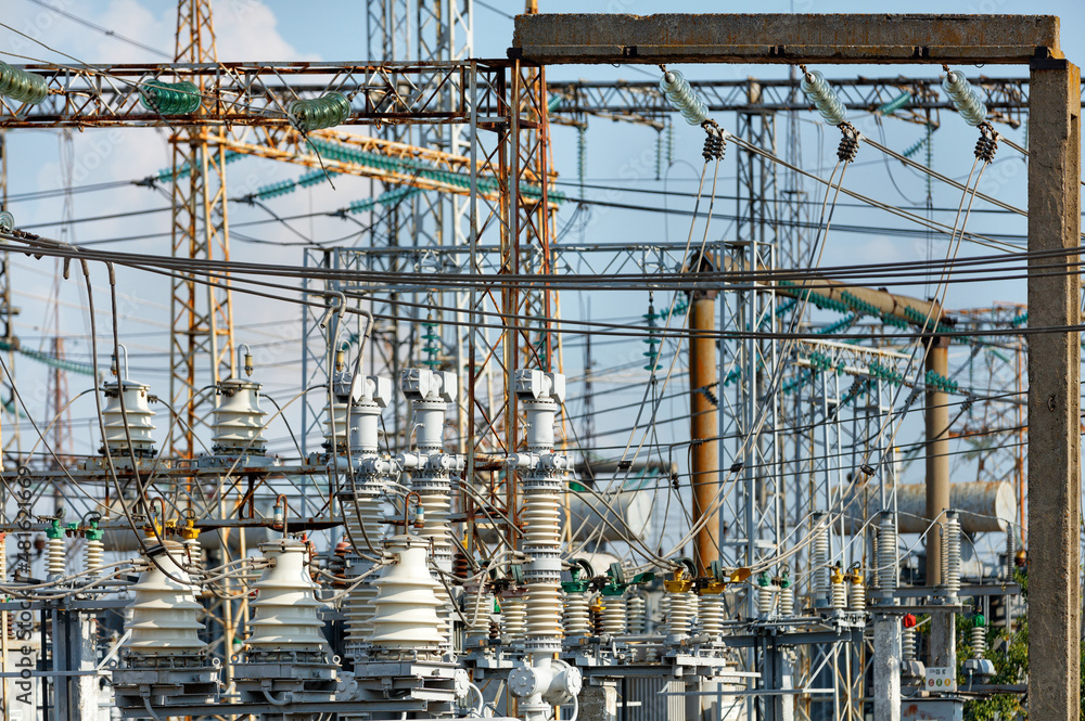 A fragment of an electrical substation with many wires and dielectric insulators.