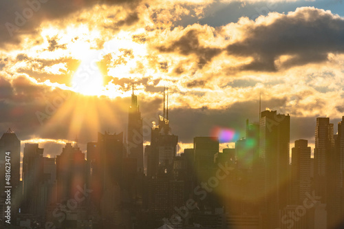 Rusing sun with beatifull cloudscope above the Nyc skyline.