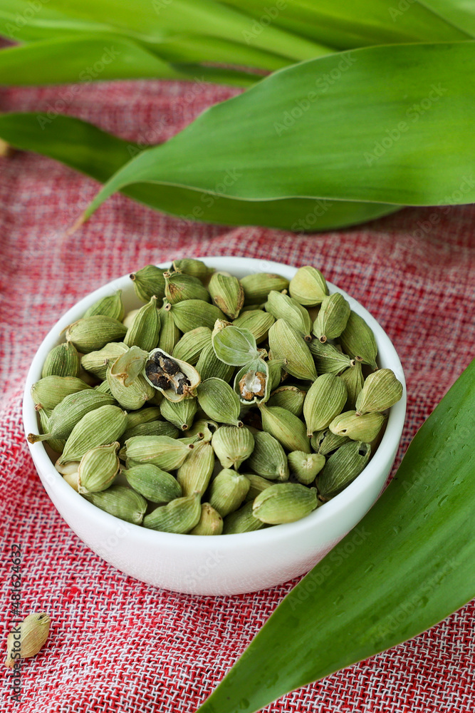 Heap of fresh organic green cardamom pods spice Indian spices for Indian cooking Masala hot