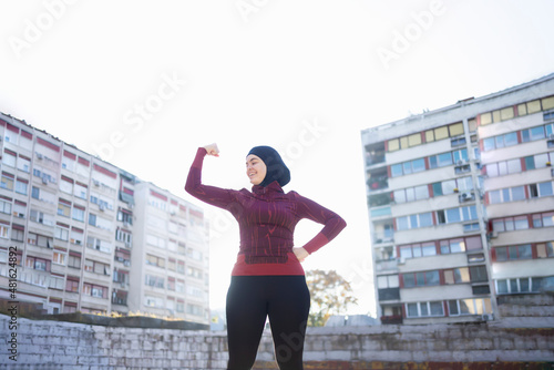 Young and happy Muslim woman expressing her strength