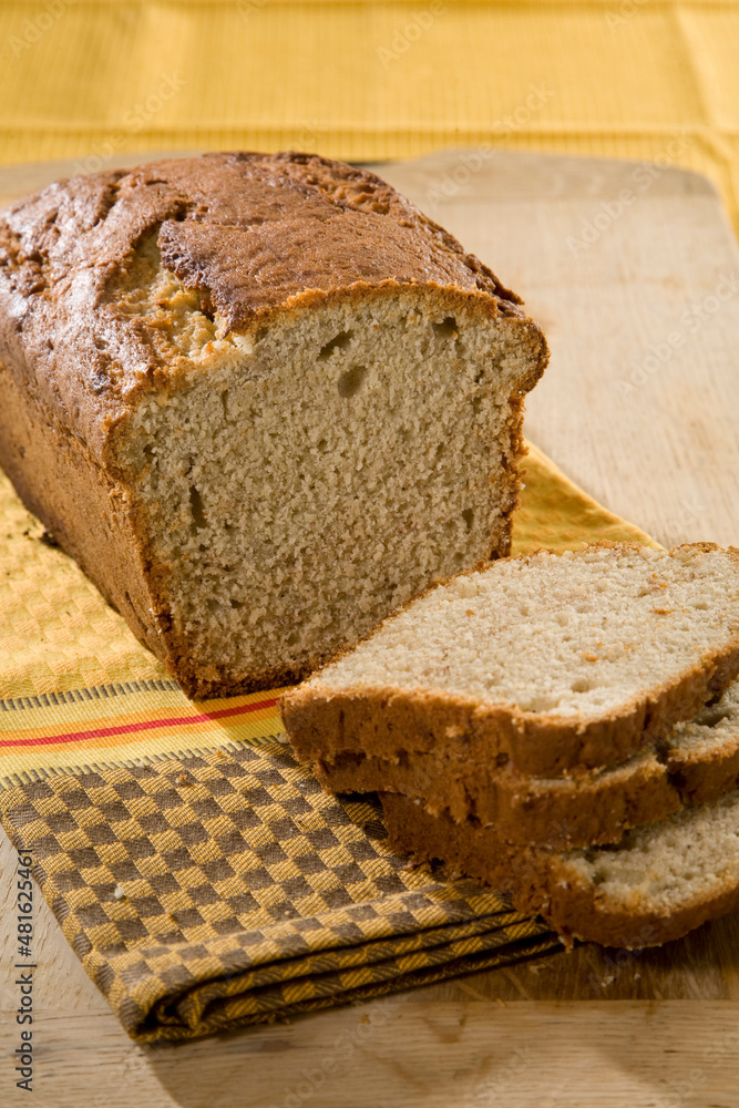 Delicious freshly baked bread, sliced and ready to serve in a homestyle setting. Delicious freshly baked bread, sliced and ready to serve in a homestyle setting.
