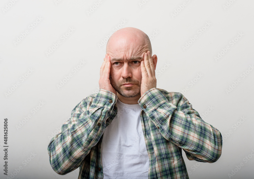 bald man having a headache bald man having a headache