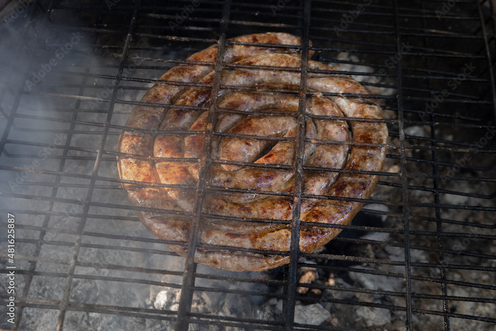 South African lamb sausage, known as boerewors, being grilled over hot