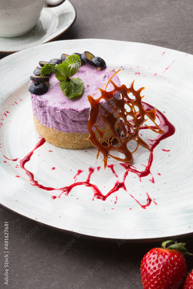 Fresh blueberry cake decorated served with cup of tea