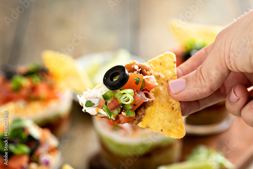 Seven layer dip in individual cups, mexican appetizer