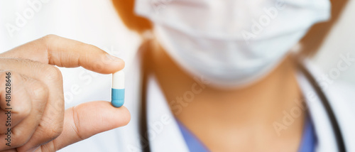 Doctor is holding pills and vitamins given to the patient