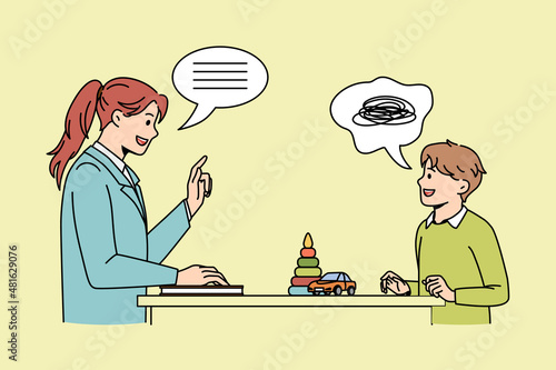 Communication and learning class concept. Young smiling woman teacher standing and talking to small boy teaching him during class vector illustration 