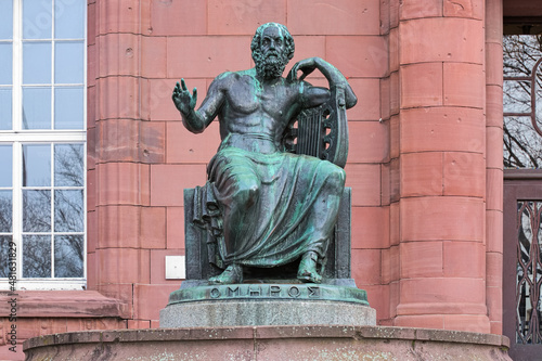Freiburg im Breisgau, Germany. Homer Statue in front of the main building of the Albert Ludwig University of Freiburg. The statue was erected in 1921. Greek text on plinth means Homer. photo