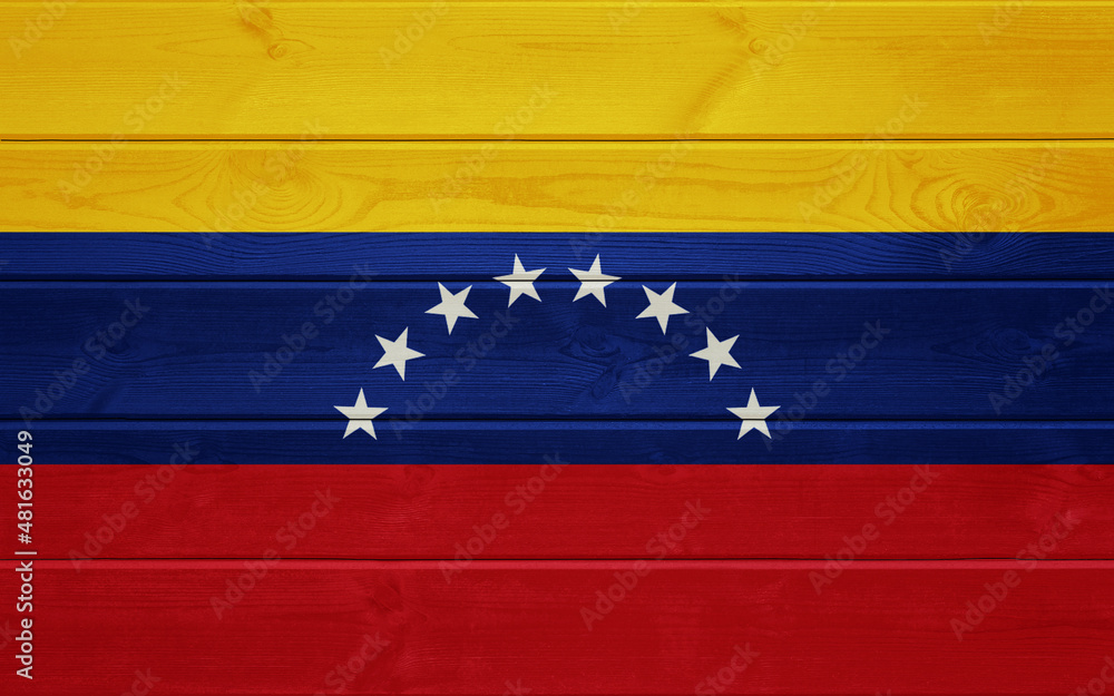 Venezuela flag on an old wooden surface. Wooden background with Venezuela flag.