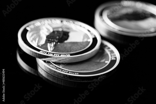 Close up of Silver Bullion Coin on a black mirror background