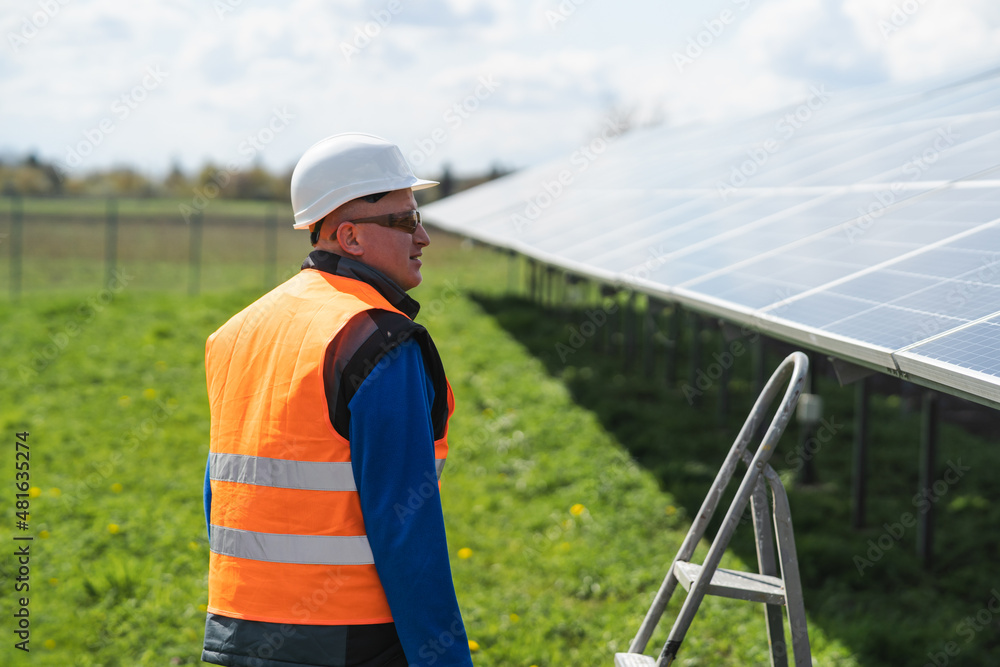 Male worker at solar panels farm