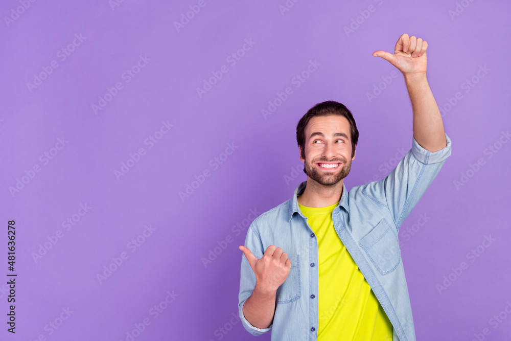 Photo of young dreamy smiling guy look copyspace advertise product showing thumb-up isolated on violet color background Photo of young dreamy smiling guy look copyspace advertise product showing thumb-up isolated on violet color background