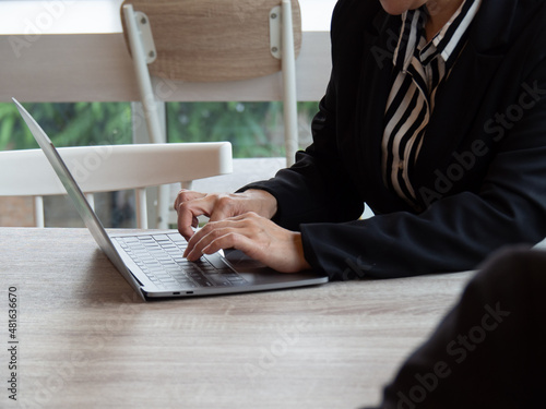 A woman using a laptop. Business office work.