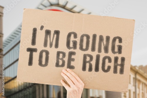 Wallpaper Mural The phrase " I'm going to be rich " on a banner in men's hand with blurred background. Prosperous. Destination. Risk. Strategy. Profit. Profitable. Employment. Productive Torontodigital.ca