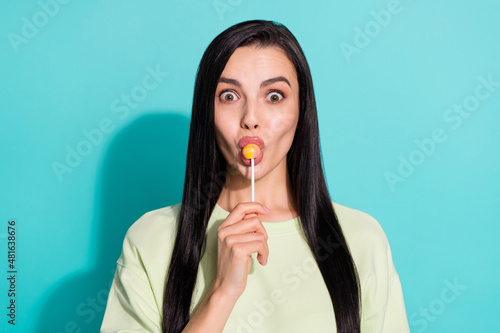 Portrait of cute lovely lady lick bright tasty candy impressed unbelievable flavor isolated over cyan color background