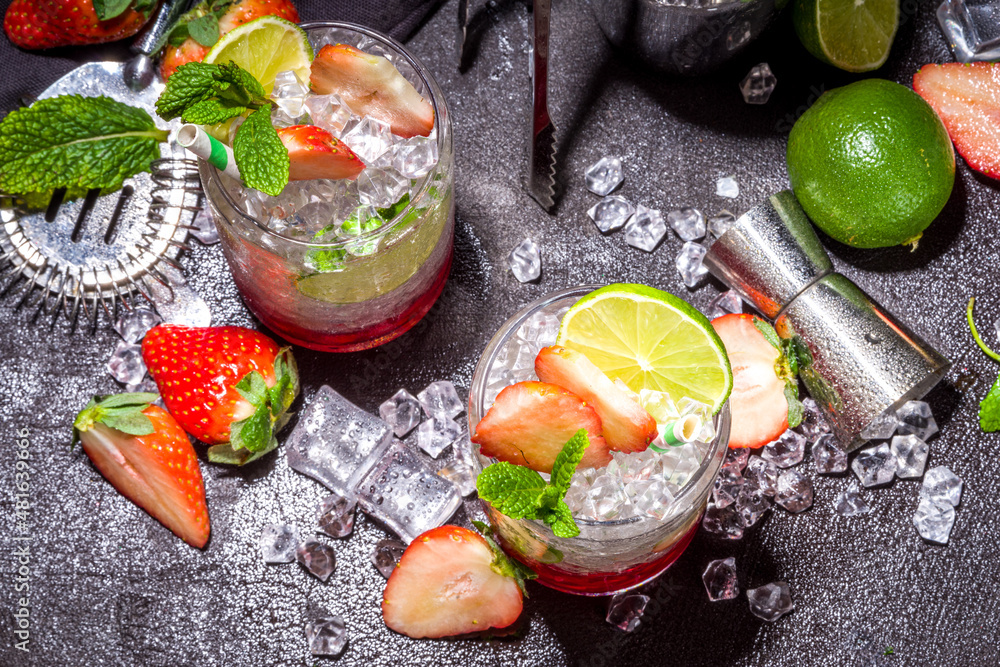 Strawberry citrus summer cooling drink, iced berry mojito lemonade with strawberries, mint and lime